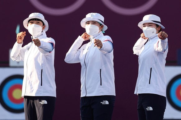 epa09363868 Gold medalist South Korea&#039;s women&#039;s team: An San, Minhee Jang and Chaeyoung Kang pose on the podium during a victory ceremony of the Archery Women&#039;s Team event during the Ar ...