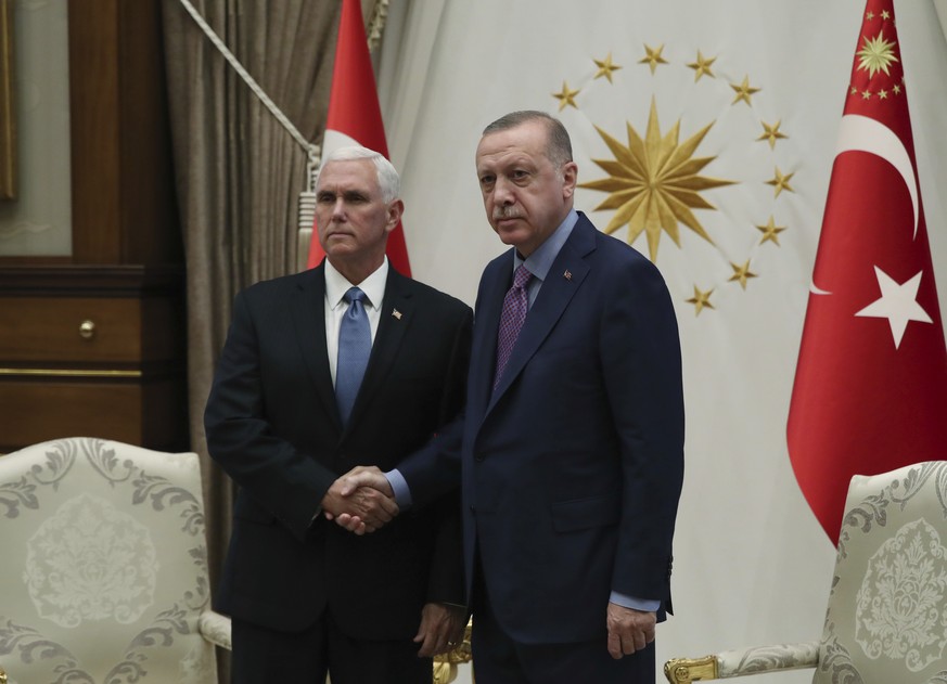 Turkey&#039;s President Recep Tayyip Erdogan, right, shakes hands with U.S Vice President Mike Pence, prior to their talks at the Presidential Palace in Ankara, Turkey, Thursday, Oct. 17, 2019. A high ...