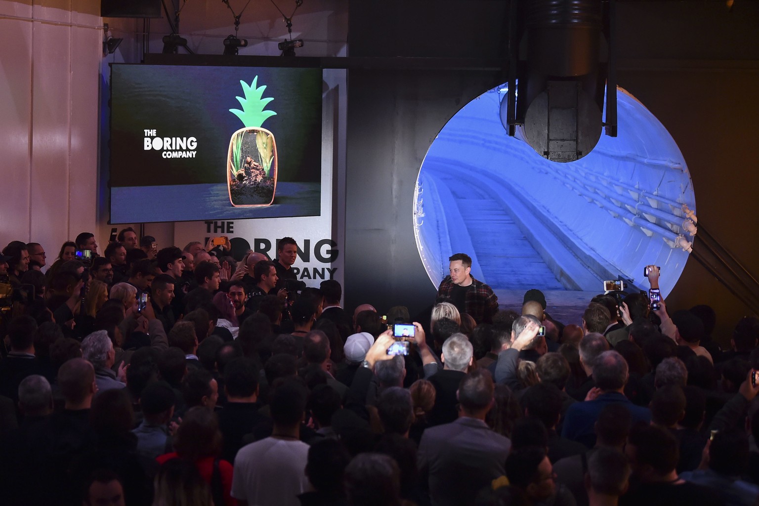 Elon Musk, co-founder and chief executive officer of Tesla Inc., walks into the crowd during an unveiling event for the Boring Company Hawthorne test tunnel in Hawthorne, Calif., on Tuesday, Dec. 18,  ...