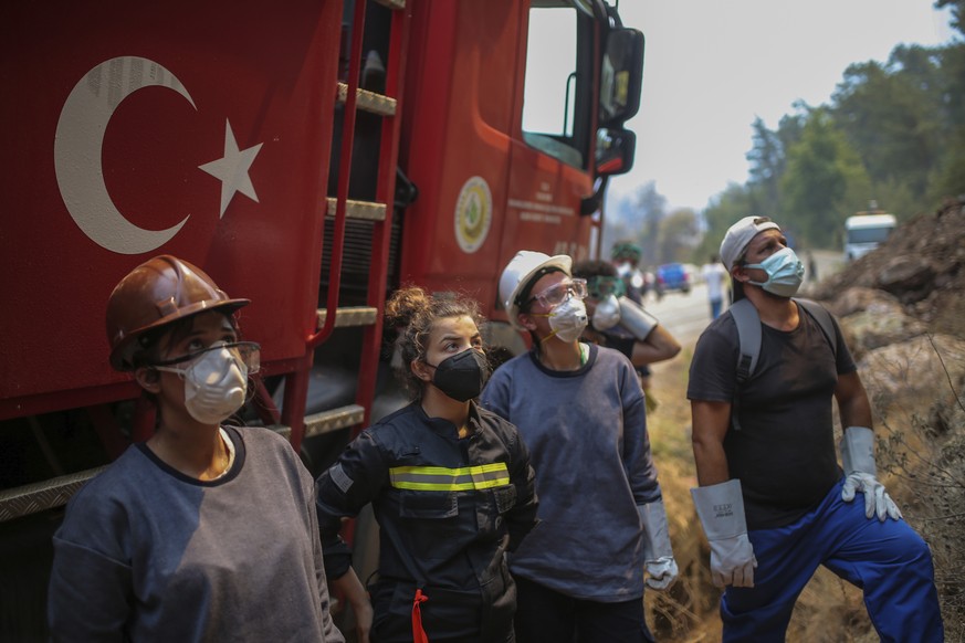 Turkish volunteers prepare to fight wildfires in Turgut village, near tourist resort of Marmaris, Mugla, Turkey, Wednesday, Aug. 4, 2021. Hundreds of volunteers have joined efforts to contain blazes t ...