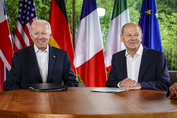 epa10037843 US President Joe Biden (L) and German Chancellor Olaf Scholz (R) chat before meeting with other G7 leaders at Elmau Castle in Kruen, Germany, 28 June 2022. Germany is hosting the G7 summit ...