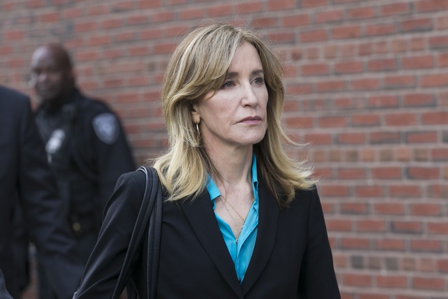 epa07483410 US actress Felicity Huffman leaves the John J Moakley Federal Court House after facing charges in a nationwide college admissions cheating scheme in Boston, Massachusetts, USA 03 April 201 ...