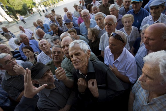 Elderly people argue with a bank worker as they wait to be allowed into a bank to withdraw a maximum of 120 euros ($134) for the week in Athens, Monday, July 6, 2015. GreeceÂs Finance Minister Yanis  ...