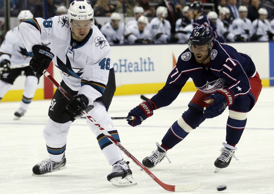 San Jose Sharks forward Tomas Hertl, left, of the Czech Republic, passes the puck against Columbus Blue Jackets forward Brandon Dubinsky during the second period of an NHL hockey game in Columbus, Ohi ...