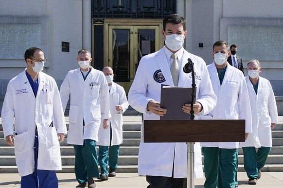 Dr. Sean Conley, physician to President Donald Trump, and other doctors, arrive to brief reporters at Walter Reed National Military Medical Center in Bethesda, Md., Sunday, Oct. 4, 2020. Trump was adm ...