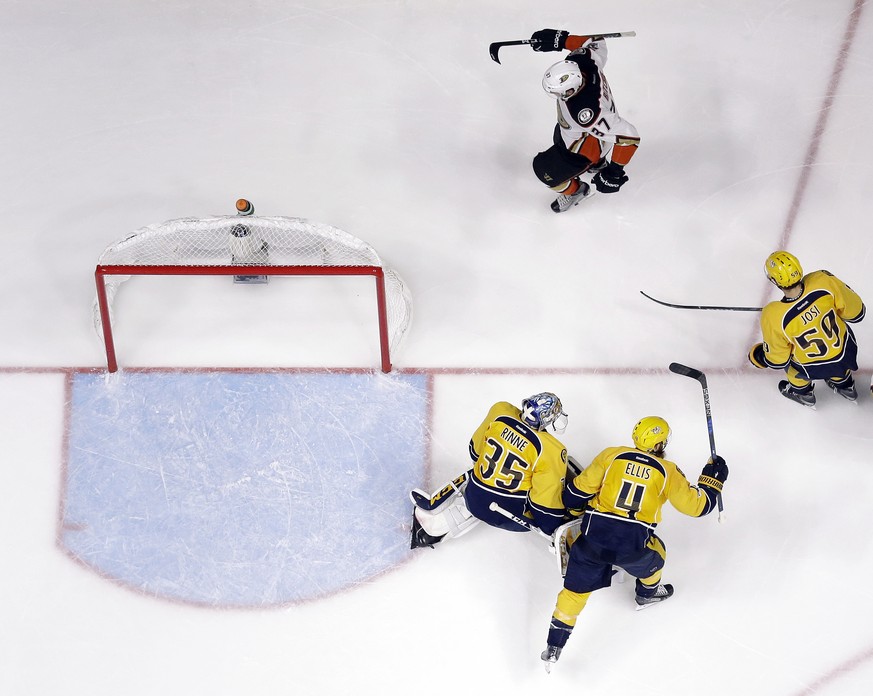 Anaheim Ducks left wing Nick Ritchie (37) celebrates after scoring a goal as he skates past Nashville Predators goalie Pekka Rinne (35), of Finland, defenseman Ryan Ellis (4) and defenseman Roman Josi ...