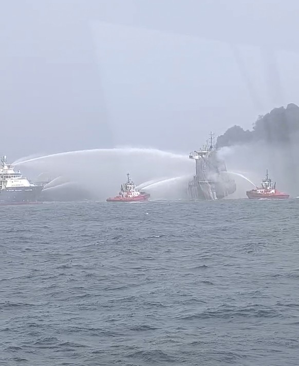 In this image taken from video provided by Denys Mezentsev, rescue crews work on site after a cargo ship was hit by a tanker carrying jet fuel for the U.S. military off eastern England, Monday, March  ...