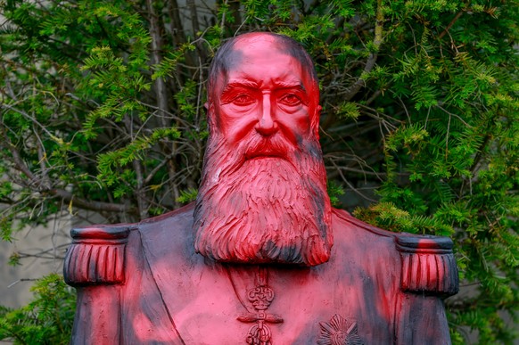 epa08476630 A statue of former Belgian King Leopold II sprayed with paint is seen at the park of the Africa Museum, in Tervuren, near Brussels, Belgium, 10 June 2020. At least two petitions were launc ...