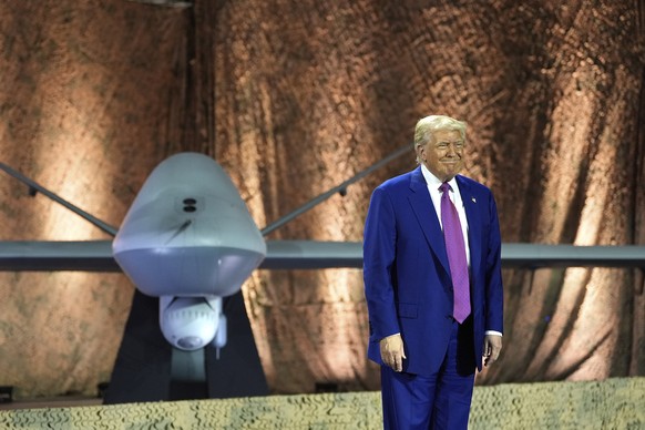 President Donald Trump stands backdropped by an MQ-9 Reaper drone before addressing military personnel at the Al Udeid Air Base, Thursday, May 15, 2025, in Doha, Qatar. (AP Photo/Alex Brandon)
Donald  ...
