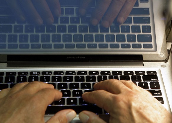 FILE - In this Feb. 27, 2013, file photo illustration, hands type on a computer keyboard in Los Angeles. Spring is a great time to clear out your digital clutter and make sure that you're adequat ...