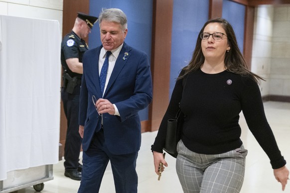 Rep. Elise Stefanik, R-N.Y., walks with Rep. Michael McCaul, R-Texas, to watch the video address by Ukrainian President Volodymyr Zelenskyy to the U.S. Congress at the Capitol in Washington, Wednesday ...