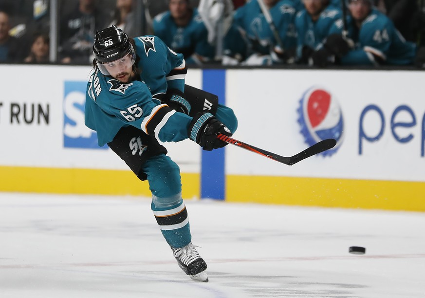 FILE- In this Sept. 27, 2018, file photo San Jose Sharks defenseman Erik Karlsson shoots against the Calgary Flames during the third period of a preseason NHL hockey game in San Jose, Calif. San Jose  ...