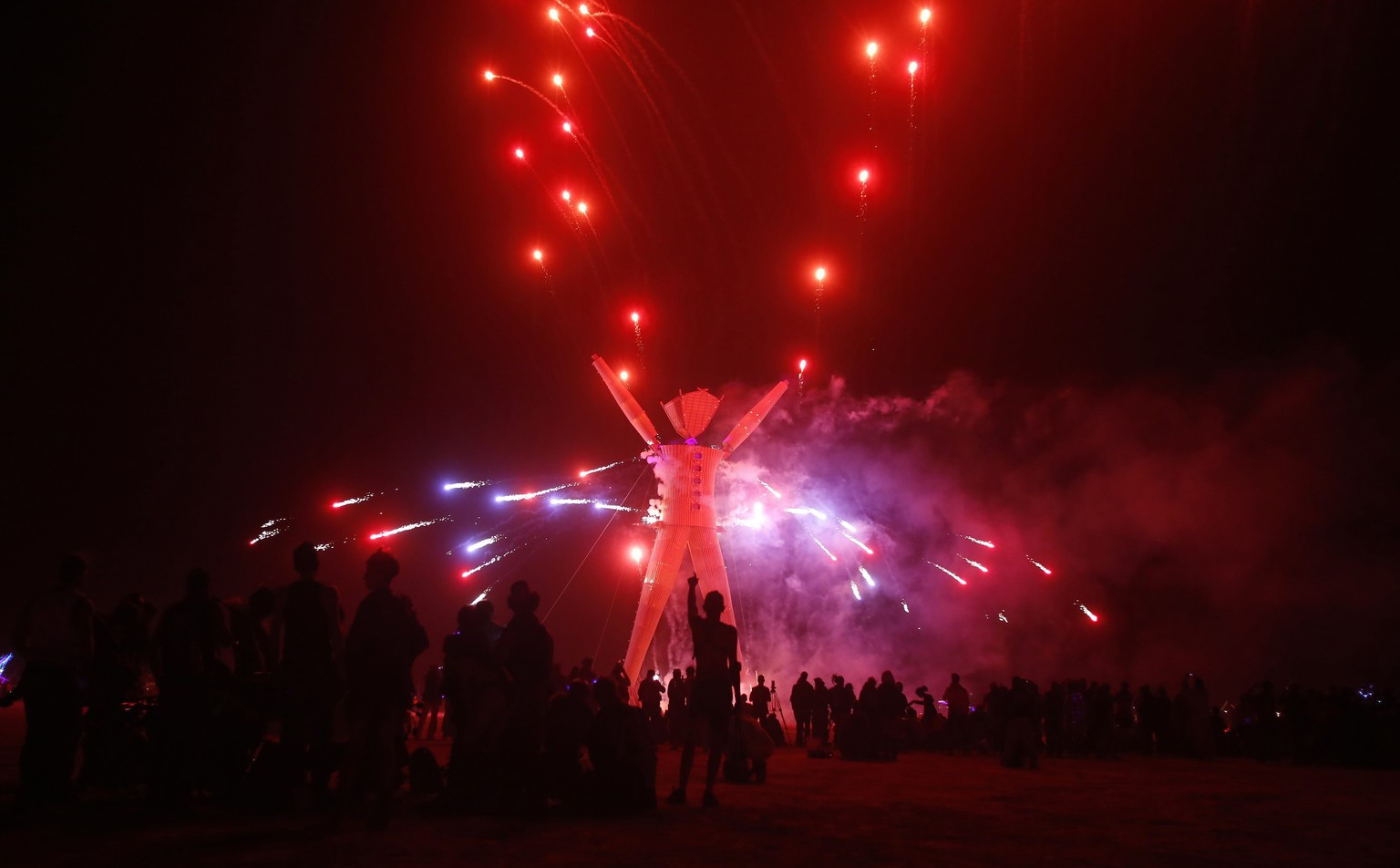 Fireworks are seen before the Man burns during the Burning Man 2014 &quot;Caravansary&quot; arts and music festival in the Black Rock Desert of Nevada, August 30, 2014. Over 65,000 people from all ove ...