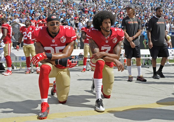 FILE - In this Sept. 18, 2016, file photo, San Francisco 49ers' Colin Kaepernick (7) and Eric Reid (35) kneel during the national anthem before an NFL football game against the Carolina Panthers, ...