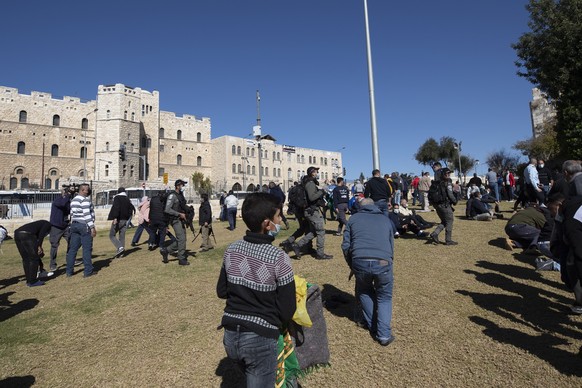 epa08926036 Israeli border police prevent Palestinians from gathering for the Friday prayer next to the Old city of Jerusalem due to the COVID-19 disease outbreak restrictions during a full lockdown i ...