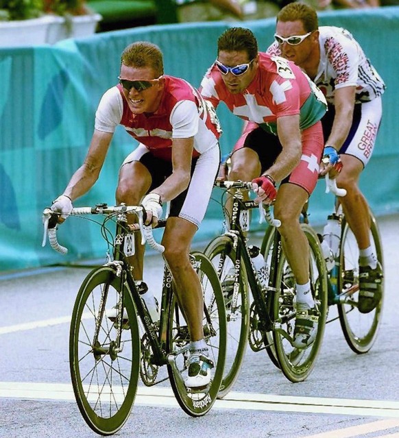 From L-R, silver medalist Rolf Sorensen of Denmark, gold medalist Pascal Richard of Switzerland, bronze medalist Max Sciandri of Great Britain take the last lap of the Olympic men&#039;s road race 31  ...