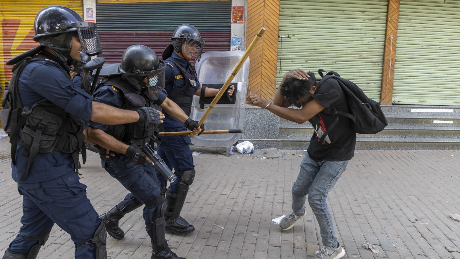 epa12362241 Police clash with a protester in front of the parliament building in Kathmandu, Nepal, 08 September 2025. Young demonstrators gathered in the capital to demand an end to corruption and the ...