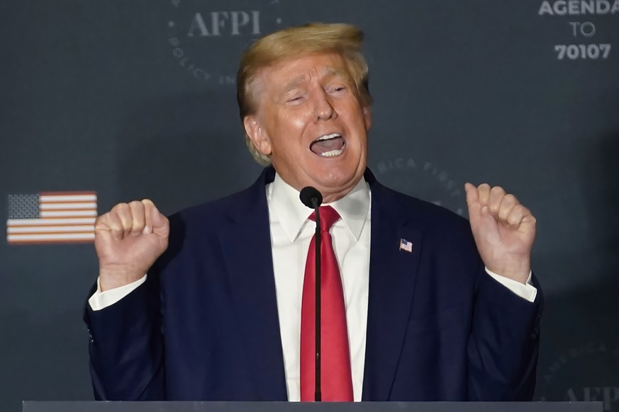 Former President Donald Trump talks about lifting weights as he speaks at an America First Policy Institute agenda summit at the Marriott Marquis in Washington, Tuesday, July 26, 2022. (AP Photo/Andre ...