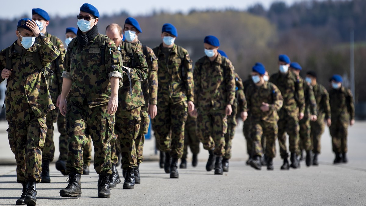 Soldiers from the Swiss Army "Bataillon Hopital 2" from "Division territoriale 1" walk as they practice health and medical exercises in the military camp before being deployed in s ...