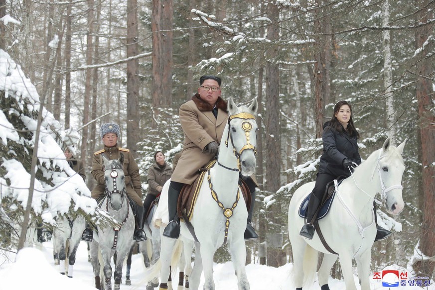 This undated photo provided on Wednesday, December 12.  4, 2019, by the North Korean government shows North Korean leader Kim Jong Un, center, riding a white horse during his visit to Mount Paektu, North Korea.