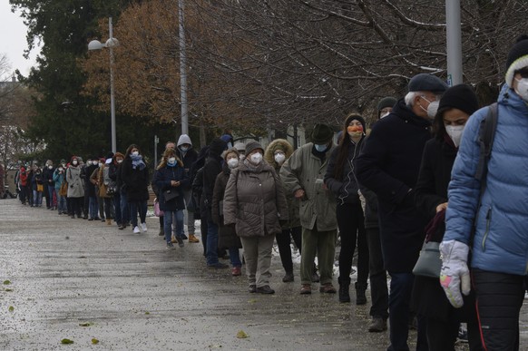 epa08861641 Viennese citizens queue up to receive rapid antigen coronavirus tests provided by the Austrian armed forces, during a nationwide mass testing at the Stadthalle event hall in Vienna, Austri ...