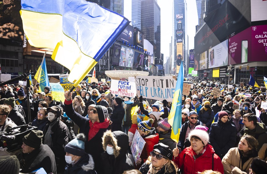 epa09787614 People gather in Times Square for a rally in support of the Ukrainian people and to protest Russia's invasion of the country this week in New York, New York, USA, 26 February 2022. Ru ...