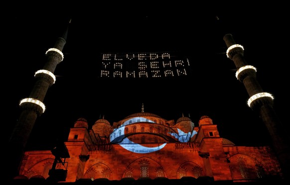 epaselect epa05406381 A Turkish national flag is projected onto the facade while a lights forming the slogan &#039;Good Bye Holy Ramadan&#039; hang between the minarets of the landmark &#039;Blue Mosq ...