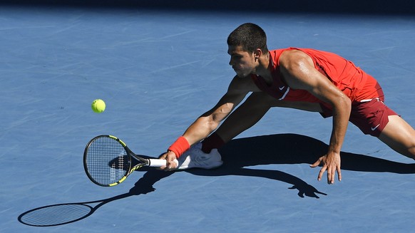 Carlos Alcaraz of Spain plays a forehand return to Matteo Berrettini of Italy during their third round match at the Australian Open tennis championships in Melbourne, Australia, Friday, Jan. 21, 2022. ...