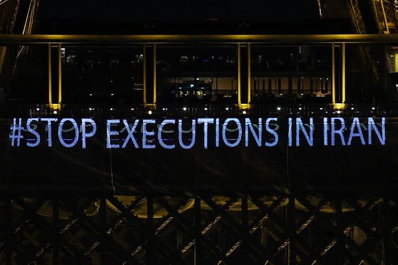 epa10409523 The Eiffel Tower displays the slogan #StopExecutionsInIran in support of the Iranian people, in Paris, France, 16 January 2023. Four months after the death of Mahsa Jina Amini in police cu ...