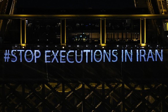 epa10409523 The Eiffel Tower displays the slogan #StopExecutionsInIran in support of the Iranian people, in Paris, France, January 16, 2023. Four months after the death of Mahsa Jina Amini in police cell ...