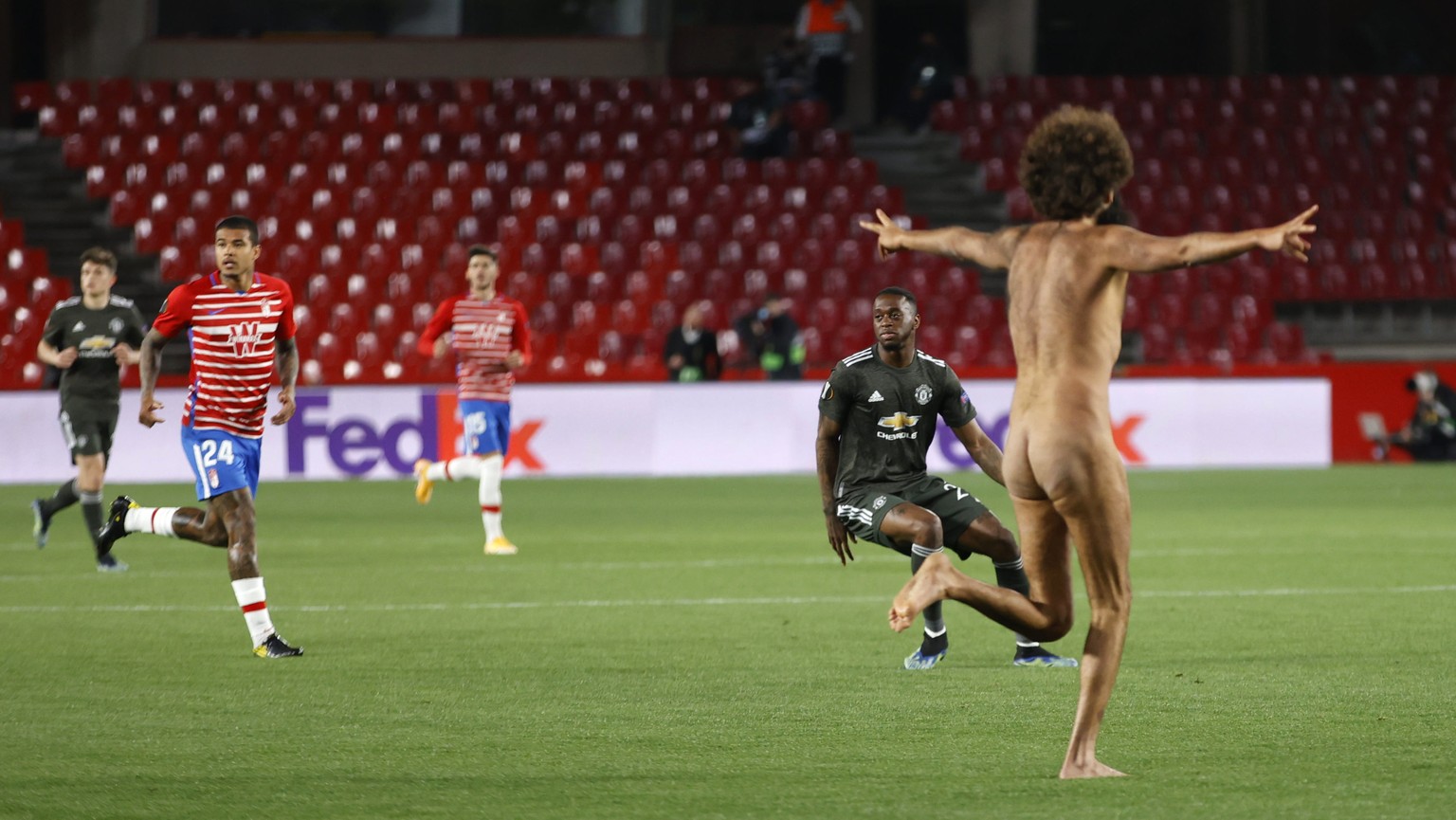 A streaker runs on the pitch during the Europa League, quarterfinal, first leg soccer match between Granada and Manchester United at the Los Carmenes stadium in Granada, Spain, Thursday, April 8, 2021 ...