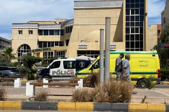 epa11991776 An ambulance and a police vehicle stand in front of The Egyptian Hospital in Hurghada, Egypt, 27 March 2025, following the sinking of a submarine in the Red Sea, with several people feared ...