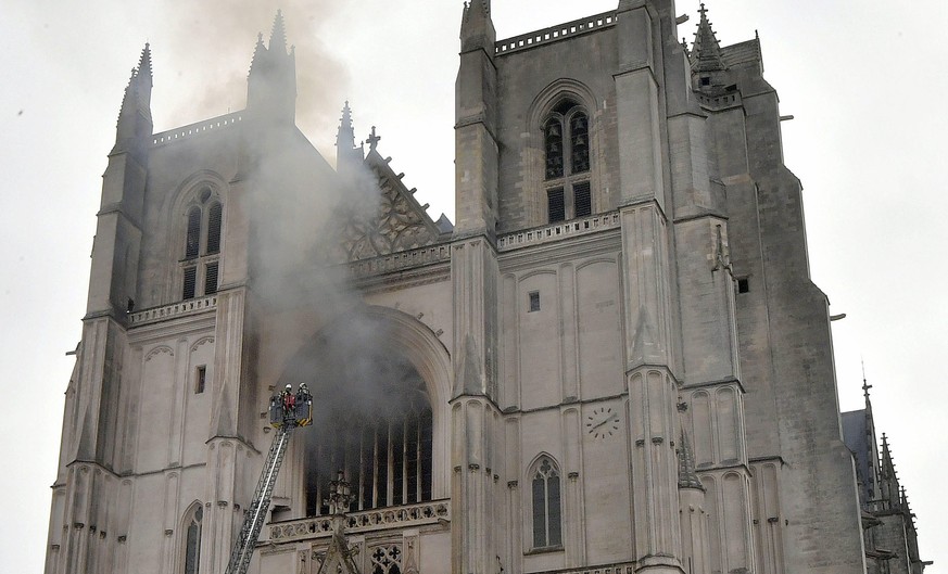 epa08553435 Fire fighters brigade work to extinguish the blaze at the Saint Peter and Saint Paul Cathedral, in Nantes, France, 18 July 2020. The blaze that broke inside the gothic cathedral of Nantes  ...