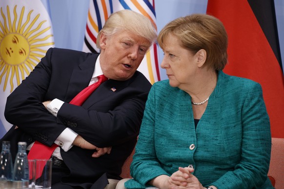 President Donald Trump, left, talks with German Chancellor Angela Merkel during the Women&#039;s Entrepreneurship Finance event at the G20 Summit, Saturday, July 8, 2017, in Hamburg. (AP Photo/Evan Vu ...