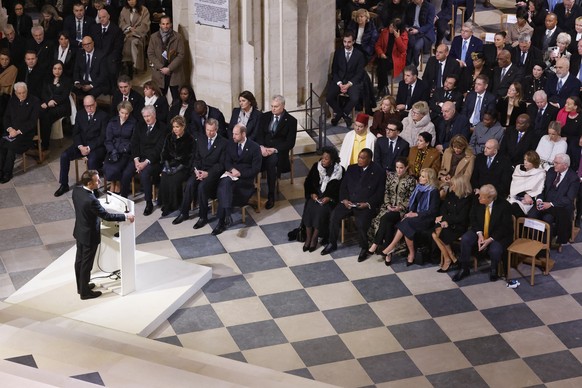 epa11763269 French President Emmanuel Macron (L) delivers a speech inside the Notre Dame de Paris cathedral, during a ceremony to mark its reopening in Paris, France, 07 December 2024. The Notre Dame  ...