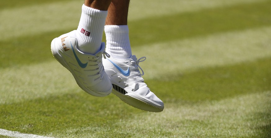 epa06857860 Roger Federer of Switzerland serves to Dusan Lajovic of Serbia in their first round match during the Wimbledon Championships at the All England Lawn Tennis Club, in London, Britain, 02 Jul ...