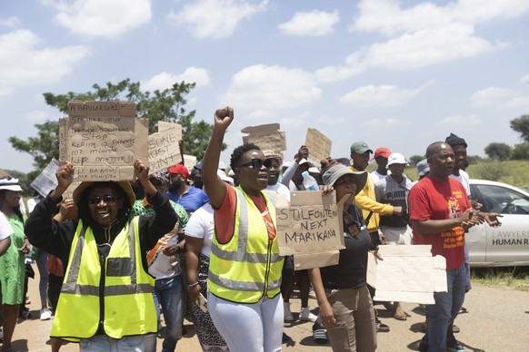 epa11823717 Local community and family members of the trapped miners gather during the official rescue attempts near the entrance to a disused gold mine shaft in Stilfontein, around 150 kilometers sou ...