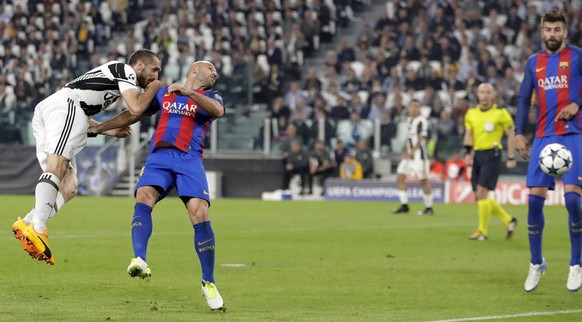 Juventus&#039;s Giorgio Chiellini, left, heads the ball past Barcelona&#039;s Javier Mascherano to score his side&#039;s third goal, during a Champions League, quarterfinal, first-leg soccer match bet ...