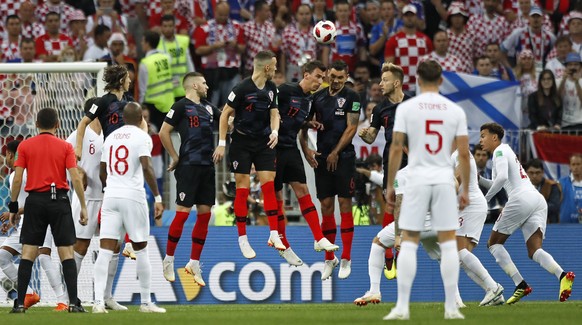 Croatia's defense jumps for a free kick by England's Kieran Trippier who scores the opening goal during the semifinal match between Croatia and England at the 2018 soccer World Cup in the Luzhniki Stadium in Moscow, Russia, Wednesday, July 11, 2018. (AP Photo/Matthias Schrader)
