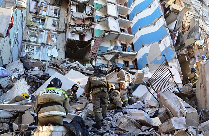 epa07255256 A handout picture made available by the Russian Emergency Situations Ministry Chelyabinsk Region shows Russian rescue workers cleaning debris after a gas explosion in an apartment building ...