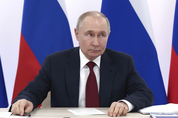 Russian President Vladimir Putin attends a meeting of the board of trustees of the Talent and Success Foundation at the Sirius Park of Science and Art after his phone talks with U.S. President Donald  ...