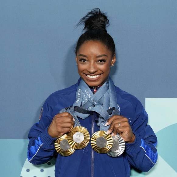 Olympics: Gymnastics Aug 5, 2024 Paris, France Simone Biles of the United States poses for a photo with her three gold and one silver medal after day three of the gymnastics event finals during the Pa ...