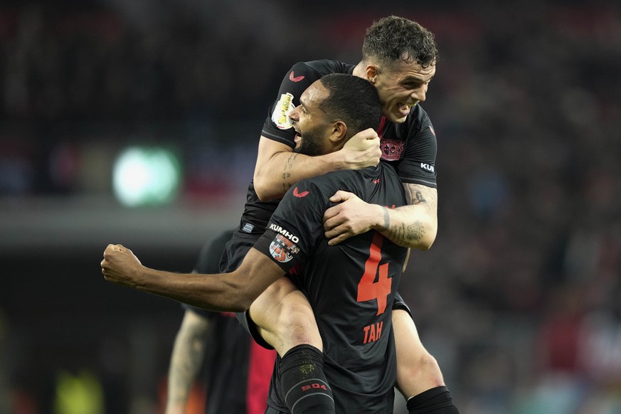Leverkusen&#039;s Jonathan Tah and Leverkusen&#039;s Granit Xhaka celebrate after the German soccer cup quarterfinal match between Bayer 04 Leverkusen and VfB Stuttgart at the BayArena in Leverkusen,  ...