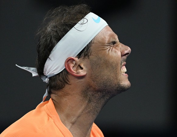 epa10412347 Rafael Nadal of Spain grimaces in pain during his match against Mackenzie McDonald of the USA during the 2023 Australian Open tennis tournament at Melbourne Park in Melbourne, Australia, 1 ...