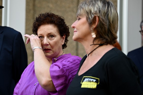 epa11027999 Kathleen Folbigg (L) wipes her eye as her friend Tracy Chapman (R) looks on after speaking to the media outside the New South Wales Court of Criminal Appeal in Sydney, Australia, 14 Decemb ...