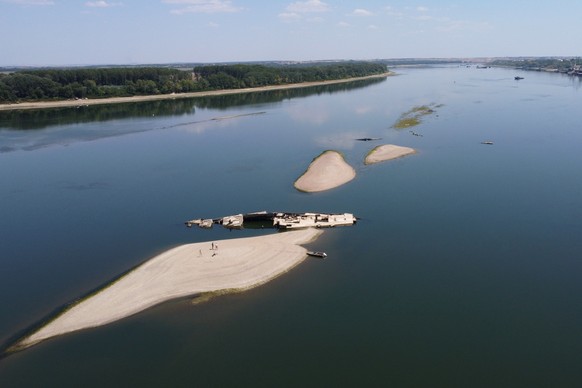 The wreckage of a WWII German warship emerges, due to the drought, in front of Djerdap II, a large dam on the Danube River, between Romania and Serbia, near Prahovo, Serbia, Tuesday, Aug. 4, 2026. (AP ...