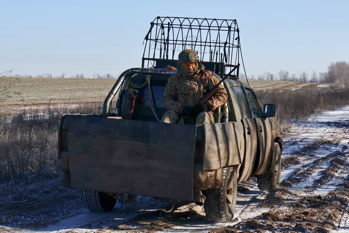 In this photo provided by Ukraine's 65th Mechanized Brigade press service, soldiers ride in the truck bed for an assignment on the frontline in the Zaporizhzhia region, Ukraine, Tuesday, Feb. 10, ...