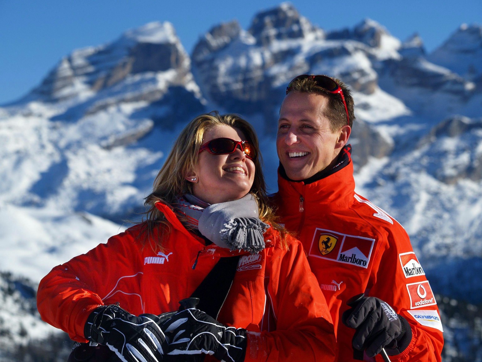 epa07258291 (FILE) German seven time Formula 1 champion Michael Schumacher (R, team Ferrari) and his wife Corinna smile in front of a mountain panorama in the ski resort of Madonna di Campiglio, Italy ...