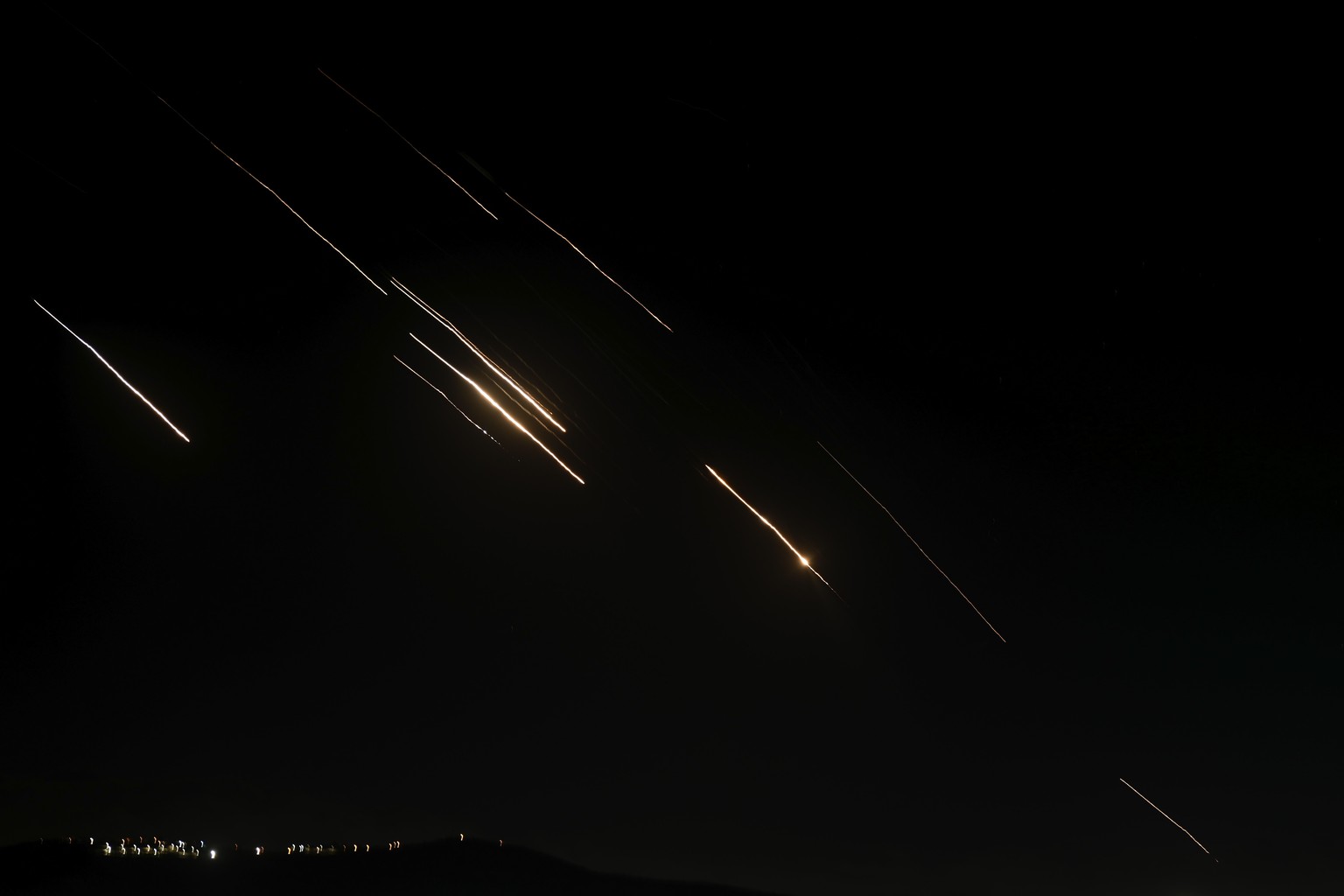Missiles launched from Iran towards Israel are seen in the West Bank city of Nablus Tuesday, Oct. 1, 2024. (AP Photo/Majdi Mohammed)