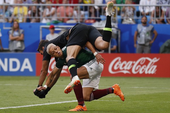 Mexico&#039;s Javier Hernandez, bottom, crashes with Brazil goalkeeper Alisson during the round of 16 match between Brazil and Mexico at the 2018 soccer World Cup in the Samara Arena, in Samara, Russi ...